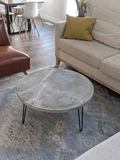 a living room filled with furniture and a table on top of a carpeted floor