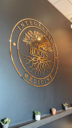 a metal sign that says roots medicine on the side of a wall with potted plants