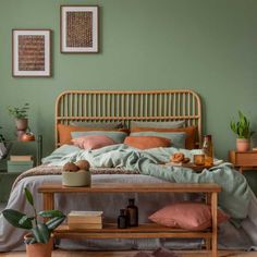 a bedroom with green walls and furniture in the corner, including a bed that has a bamboo headboard