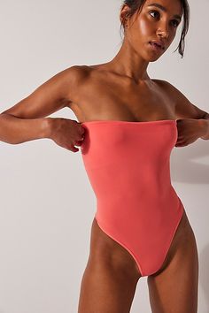 An effortlessly essential wardrobe staple, this go-to bodysuit is featured in a strapless style and ultra-comfy seamless construction. **Fit:** Pull-on style, thong bottom, high-cut legs **Features:** Strapless, tube style, smooth fabrication, seamless design **Why We | Tati Seamless Tube Bodysuit by Intimately at Free People in Orange, Size: M/L Bday List, Essential Wardrobe, Boho Clothing, High Cut, Boho Outfits, Wardrobe Essentials, Wardrobe Staples, Free People, Coral