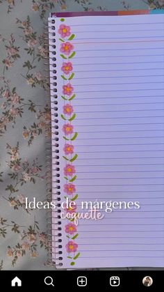 an open notebook with pink flowers on it