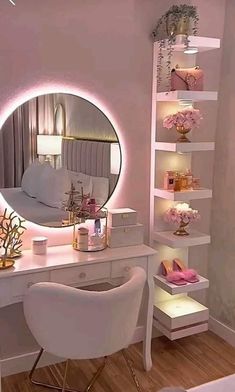 a white desk topped with a mirror next to a shelf filled with candles and flowers