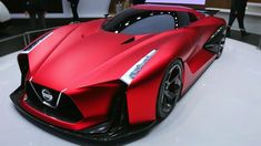 a red nissan sports car on display at an auto show