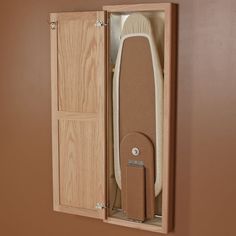 a wooden box with a surfboard in it and the door open to show its contents