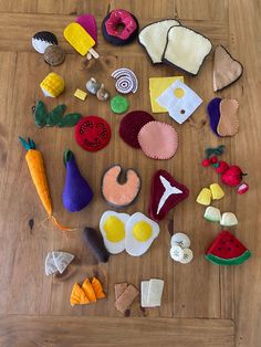 several felt fruits and vegetables are laid out on the floor