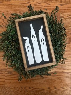 a wooden frame with some fake toothbrushes in it on top of a table