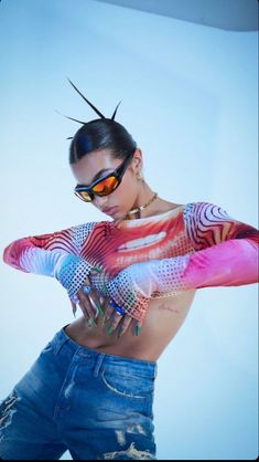 a woman with tattoos and sunglasses posing for the camera