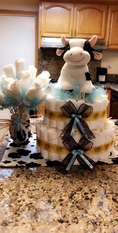 there is a cake made to look like a cow and flowers on the counter top