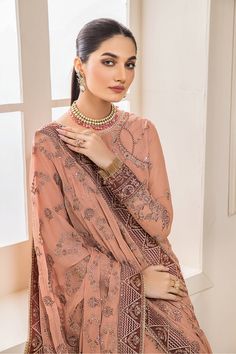 Classic Embroidered Peach Pakistani Salwar Kameez Dupatta Salwar Suit is a gorgeous attire on a raw silk canvas that features stunning embroidery in shades of pink, green, and gold tilla . It's paired with a Mughal-inspired gold-pasted dupatta. Embroidered Kameez: Pakistani Kameez salwar is balanced in the work of the threadwork kameez with heavy zardozi work on the kameez and the neckline is adorned with multi-color and gold beads. The back of the shirt is plain and the sleeves are made of net Pink Long Sleeve Raw Silk Anarkali Set, Pink Churidar With Dabka Work For Reception, Pink Chanderi Long Sleeve Churidar, Pink Dabka Work Churidar For Reception, Pink Long Sleeve Chanderi Churidar, Elegant Pink Churidar For Reception, Pink Chanderi Salwar Kameez For Reception, Pink Chandbali Salwar Kameez In Georgette, Pink Zari Work Churidar For Reception