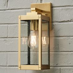 a light fixture on the side of a brick wall with two lights attached to it