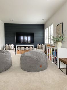 a living room filled with furniture and a flat screen tv mounted to the side of a wall