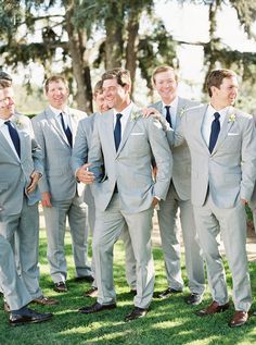 a group of men in suits standing next to each other