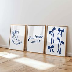 three framed art prints on the wall in an empty room with hard wood flooring