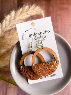 New Design from Little Studio Design Co! Gorgeous Ginger Leopard Suede Hoop Earrings! Lightweight and full of style! Perfect for everyday or something extra! Beautiful cherry wood arch paired with a Ginger Leopard Suede Leather! Beautiful russet colored leather with a gold metallic leopard print.  These earrings are beautiful! *Nickel free Earwire *Handmade in Michigan *1.5in diameter Thank you so much for supporting our shop! We love your support and your referrals! Brown Hoop Earrings With Ear Wire For Gift, Brown Hoop Earrings Gift, Brown Single Hoop Earring As Gift, Brown Hoop Earrings For Gift, Brown Small Hoop Earrings As Gift, Brown Hoop Earrings With Ear Wire, Brown Small Hoop Earrings With Ear Wire, Holiday Earrings, Diy Jewelry To Sell