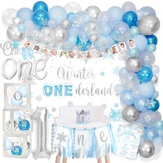 a blue and silver birthday party with balloons, streamers, decorations, and other items