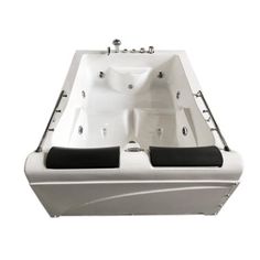 a large white bath tub with two black seats