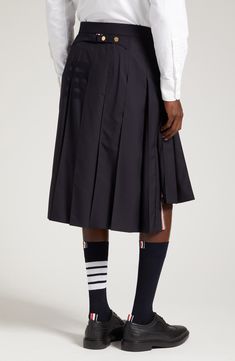 Tonal 4-Bar stripes skim the left side of this pleated wool skirt featuring a signature strap detail spanning the back waist. Tricolor grosgrain trim peeking beneath the high-low hem adds another classic Thom Browne touch. 23" center front length; 27" back length (size 2) Zip fly with hook-and-bar closure Cupro lining 100% wool Dry clean Made in Italy Men's Designer Clothing Mens Skirt, Thom Browne Menswear, Asheville Wedding, Winter Capsule, Navy Skirt, High Low Skirt, 2024 Fashion