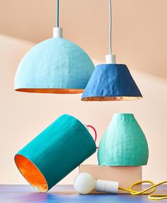 three different colored lamps hanging from the ceiling