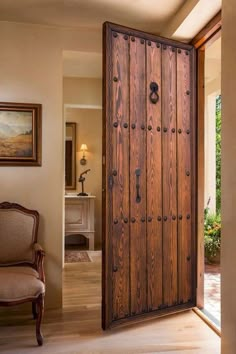 a large wooden door is open to the living room