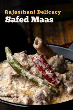 a bowl filled with meat and vegetables on top of a wooden table