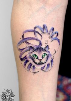 a cat with green eyes and purple hair on the arm