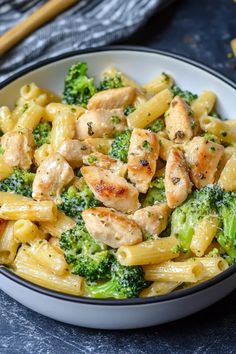 pasta with chicken and broccoli in a white bowl