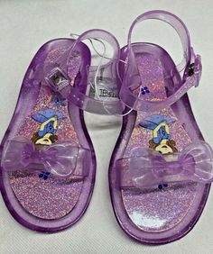 New Disney Store Sofia The First Purple Jelly Glitter Sandals. Size 12.  Shipped with USPS First Class mail. Party Closed-toe Plastic Sandals, Closed Toe Plastic Sandals For Party, Glitter Round Toe Jelly Sandals For Party, Glitter Jelly Sandals For Summer, Glitter Jelly Sandals With Round Toe For Summer, Summer Glitter Jelly Sandals With Round Toe, Adjustable Glitter Sandals, Adjustable Glitter Sandals With Round Toe, Glitter Sandals