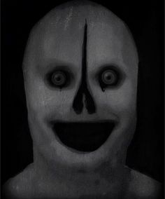 a creepy mask with big eyes and a smile on it's face is shown in black and white