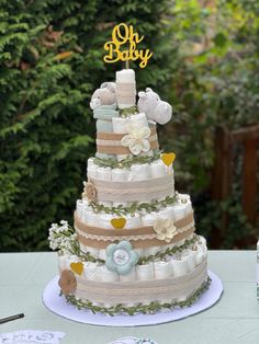 a three tiered baby shower cake with teddy bears and flowers on the top layer