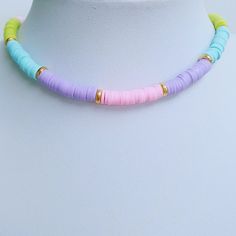 Multi Colour Heishi Beaded Choker Necklace, Polymer Clay Heishi Choker, Rainbow Colour Jewellery, Boho Summer Jewellery, Gift For Her This pretty choker necklace is handmade using 6mm Polymer Clay Heishi beads in a rainbow of colours and 6mm Gold Tone Spacer beads. It is finished off with a gold plated lobster clasp. The length of the necklace is approx 15 inches. I will also include a pretty organza bag. PLEASE NOTE ~ post can take up to 2 weeks to arrive within the UK at the moment, and up to 32 working days to arrive in the USA. Pretty Choker Necklace, Colour Jewellery, Necklace Polymer Clay, Summer Jewellery, Rainbow Colour, Hippie Necklace, Beaded Choker Necklace, Heishi Beads, Jewellery Gift