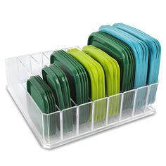 a stack of green and blue plates in a plastic holder