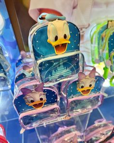 some little bags that are on display for sale in a store with donald duck decorations