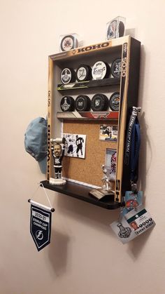 a wall mounted display case with hockey memorabilia on it's sides and an autograph badge hanging from the bottom