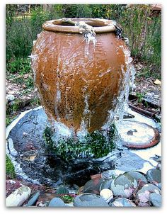 an advertisement for how to make a fantastic garden fountain with water pouring out of it