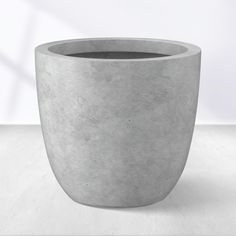 a concrete planter sitting on top of a white table