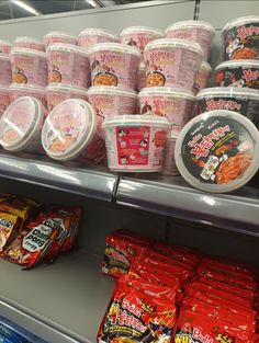 many different types of ice creams are on display in a grocery store, including yogurt and ramen