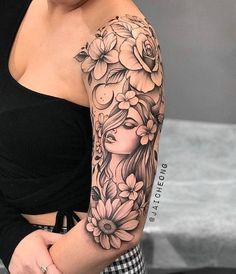 a woman with flowers on her arm and shoulder