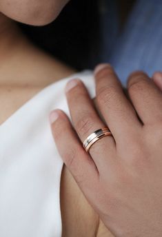 a close up of a person wearing a wedding ring