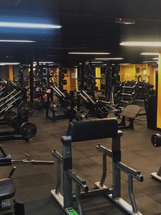 an empty gym with rows of weight machines