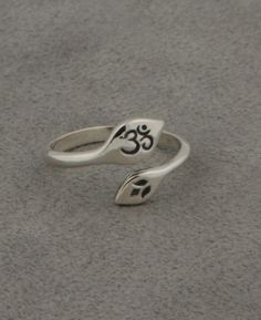 The lotus rises from the mud before blossoming in the sun, a journey that represents our own spiritual path. The Om symbol is a powerful sign of life and creation within the universe. Together, these symbols may inspire a life lived with courage and compassion. Wear them both with this dainty ring, featuring the Om symbol on a sterling silver lotus petal. Ring's "Om" petal measures about 0.375 inches wide and 0.25 inches long. The ring's open band adjusts to fit most ring sizes. Lotus petal ring Mantra Ring, Buddha Groove, Metal Jewelry Making, Lotus Ring, Lotus Jewelry, Lotus Earrings, Meaningful Jewelry, The Lotus, Spiritual Path