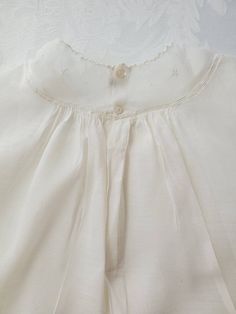 Gah! This beautiful vintage baby dress is just too beautiful Do you know a Mama expecting a little princess this summer? This vintage classic is beautifully hand-smocked and embroidered, and will be the perfect gift! Pair it with with a few plain bloomers and a silver rattle or engraved bracelet, and you have a darling gift for your expectant friend! This speaks to a classic sweet style, the classic smocking, and all things prim and proper! Adorable! There is no sizing so I would say 0-6 months. Embroidered Fitted Baptism Dress For Summer, Fitted Embroidered Baptism Dress For Summer, Summer Embroidered Fitted Baptism Dress, Spring Baptism Dress With Smock Detail, Summer Baptism Dress Embroidered, Summer Baptism Dress With Embroidery, Summer Embroidered Baptism Dress, Smocked Baptism Dress For Summer, Smock Dress For Baptism In Summer