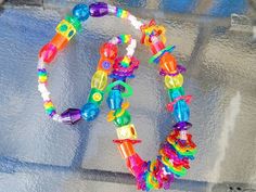 Rave Style Plastic Jewelry For Festivals, Playful Rainbow Jewelry For Festivals, Multicolor Rave Jewelry For Festival, Multicolor Rave Festival Jewelry, Cute Multicolor Plastic Necklaces, Multicolor Plastic Rave Jewelry, Handmade Multicolor Rave Necklaces, Funky Multicolor Festival Necklaces, Fun Rainbow Necklace For Birthday