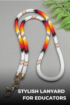 Elevate your professional style with this meticulously crafted white and orange teacher lanyard. Handcrafted using premium Japanese seed beads, this lanyard ensures durability and elegance. Ideal for securely carrying keys, ID cards, and badges with a touch of sophistication. Experience the perfect blend of functionality and fashion with this exceptional accessory that complements your daily essentials seamlessly. Elevate your everyday routine effortlessly with this stylish lanyard in hand! Adjustable White Lanyard With Key Leash, White Adjustable Lanyard With Key Leash, White Badge Holder With Key Clip For Personal Use, Adjustable White Lanyard, White Lanyards With Key Clip For Everyday Use, White Lanyard With Key Clip For Everyday Use, White Beaded Lanyards For Personal Use, Adjustable White Lanyard With Keychain, White Lanyards With Key Clip