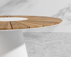 a wooden table sitting on top of a cement floor