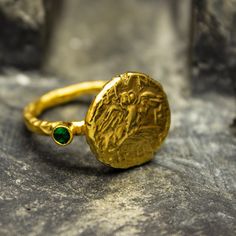 Ancient Greek Owl Athena Coin Ring | 24K Gold Plated 925 Sterling Silver | Gold Greek Athenian Tetradrachm Ring | Handmade Ring Our shop offer free ring sizing and color options.(Oxidized(Black),Gold Plated) Handcrafted hammered full round ring band size measures 2mm in width and 24k gold plated bronze coin 14.5x14.5 mm Metal : 925 Sterling Silver Plated : 24K Gold Band Width : 2 mm Gem Stone : Green Diamond Cut Cubic Zirconia Gem Color : Green,Navy Blue,Purple,Blue,White,Red (The color you want Ancient Greek Ring, Ancient Rings, Ancient Greek Jewelry, Greek Ring, Gold Armband, Bronze Ring, Greek Jewelry, Coin Ring, Ancient Jewelry