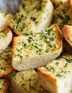 slices of garlic bread with herbs sprinkled on them