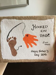 someone is holding up a handmade father's day card with an image of a fish on it