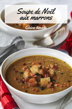 soup in a bowl with bread croutons on top and red napkins next to it