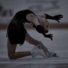 a female figure skating on an ice rink