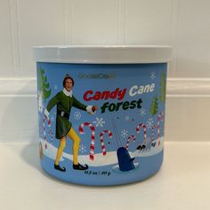 a candy cane frosted jar with a man in green coat and yellow pants on it